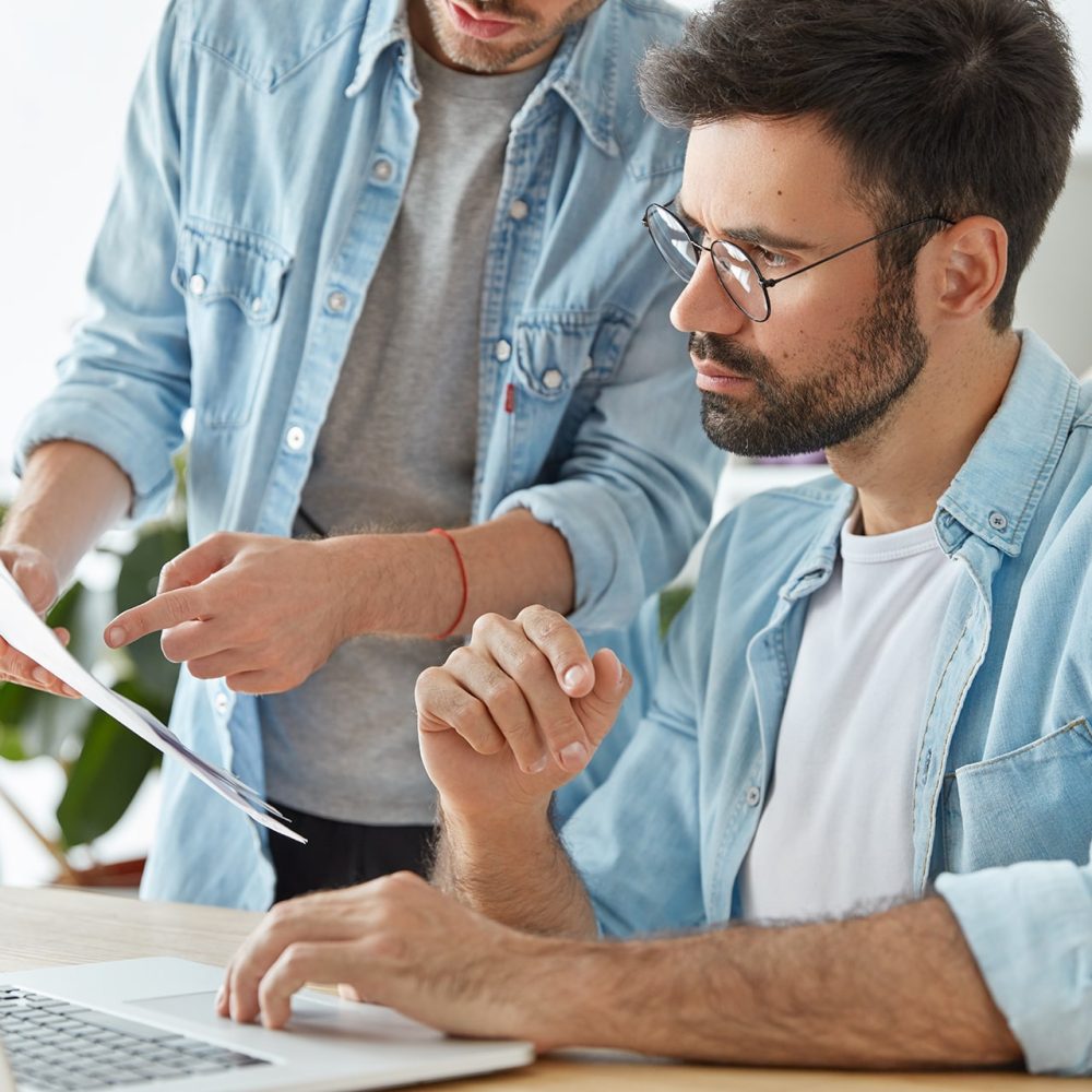 two-business-young-successful-workers-collaborate-together-coworking-space-min